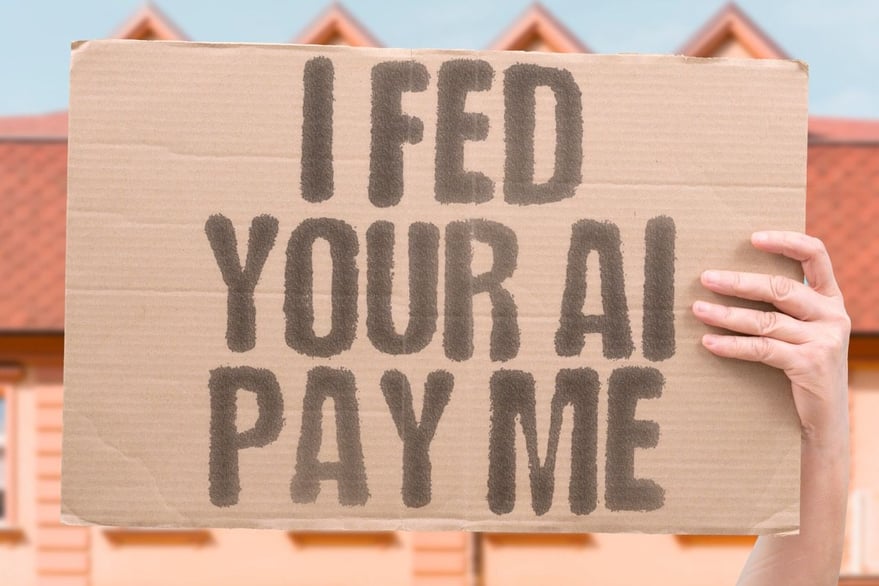 AI-Content-Licensing - Cardboard sign about compensation for AI content